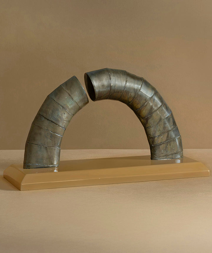 Asymetrical | Abstract bronze arch on solid marble base.