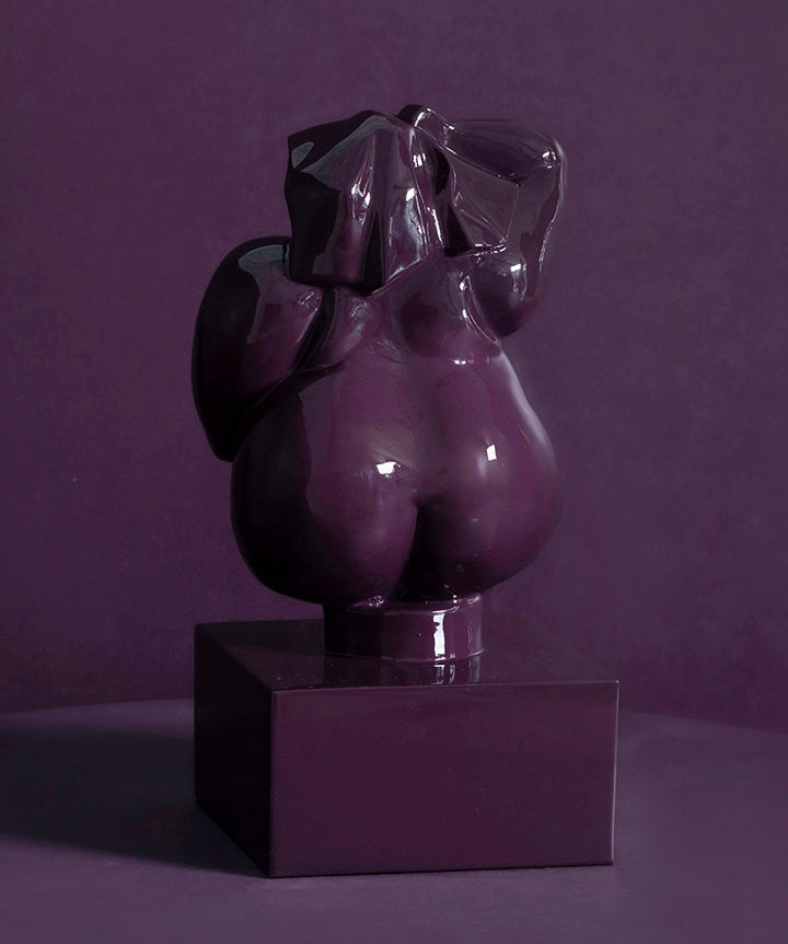 Zoftig Woman | Voluptuous bronze woman on solid marble coated in a custom high gloss urethane-based paint on a purple background.