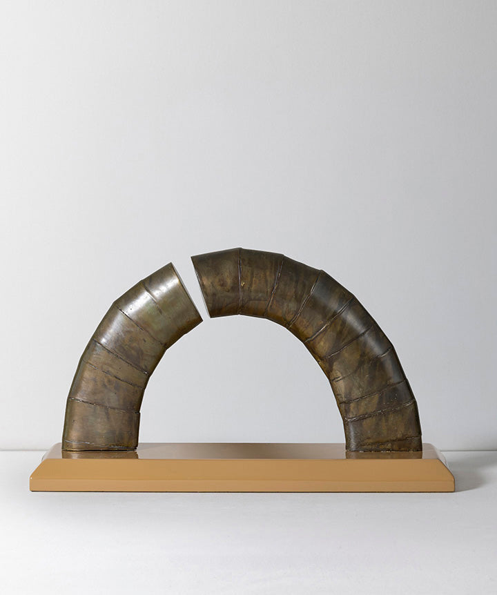 Asymetrical | Abstract bronze arch on solid marble base.