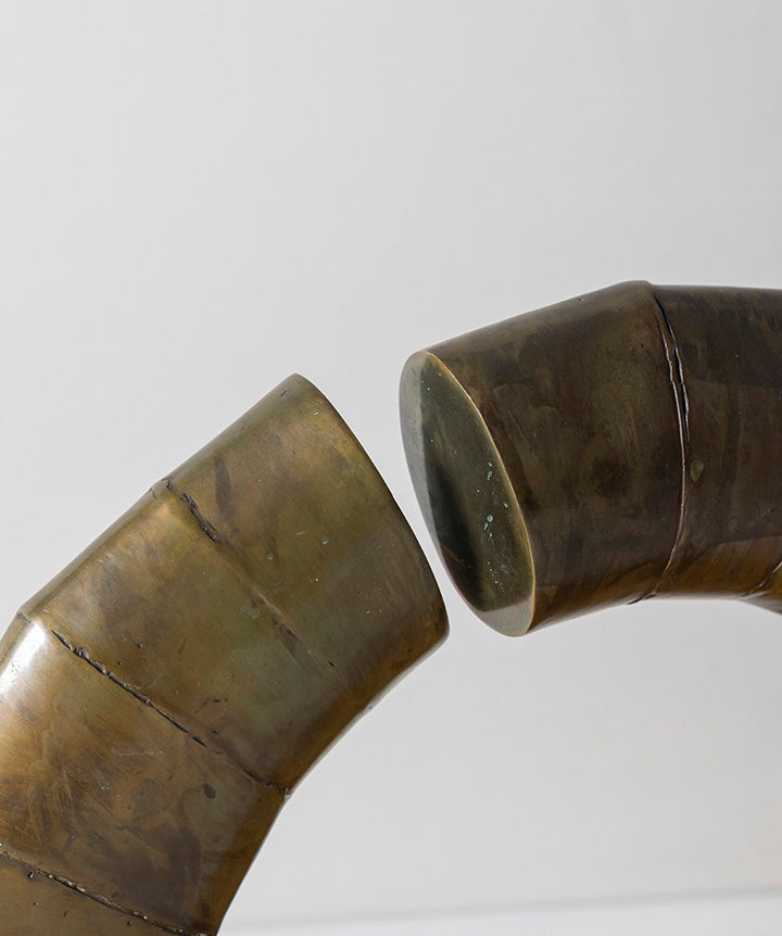 Asymetrical | Abstract bronze arch on solid marble base.